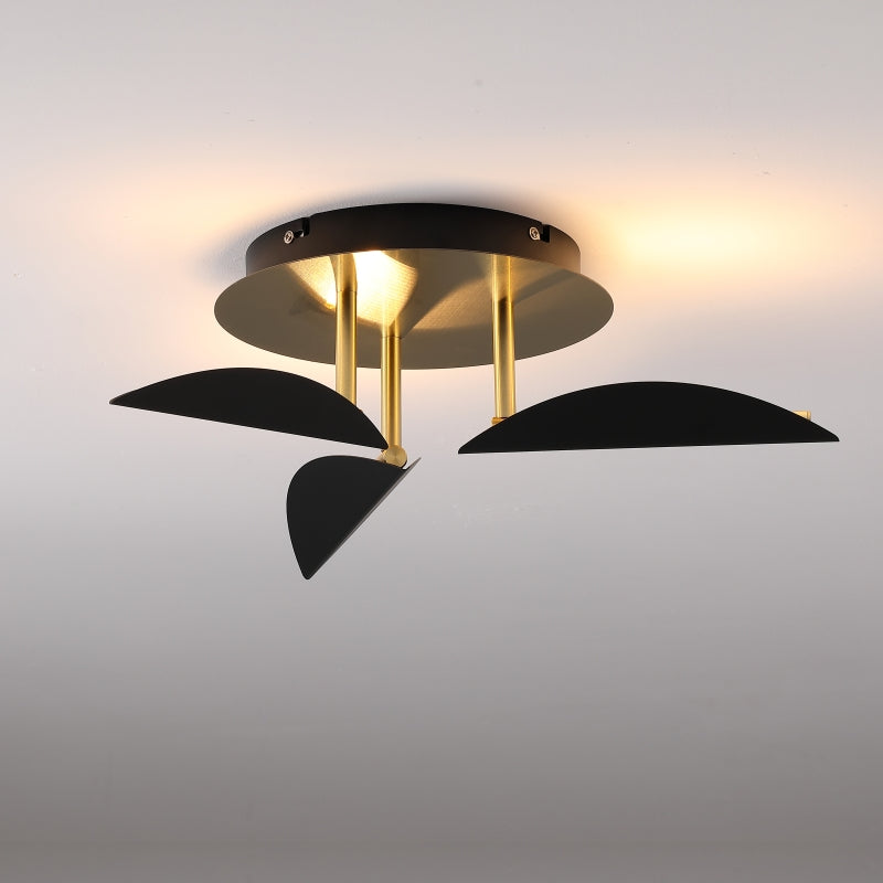 Modern ceiling light fixture with black and gold design on a gray background