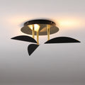 Modern ceiling light fixture with black and gold design on a gray background