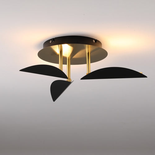 Modern ceiling light fixture with black and gold design on a gray background