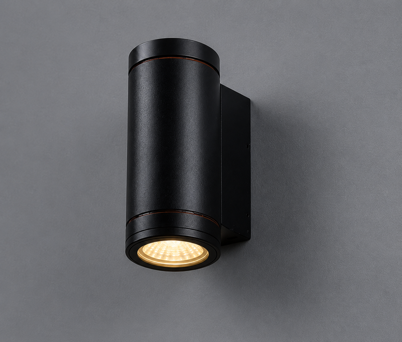 Black outdoor wall light fixture on a gray background