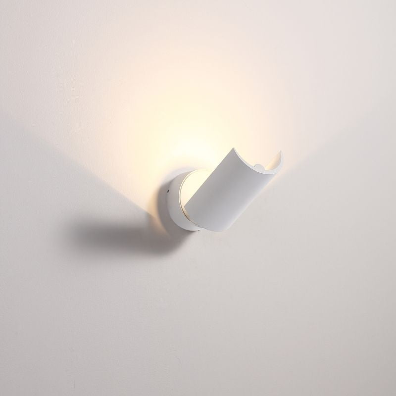 White half cylinder up light wall light fixture on a pale grey background.